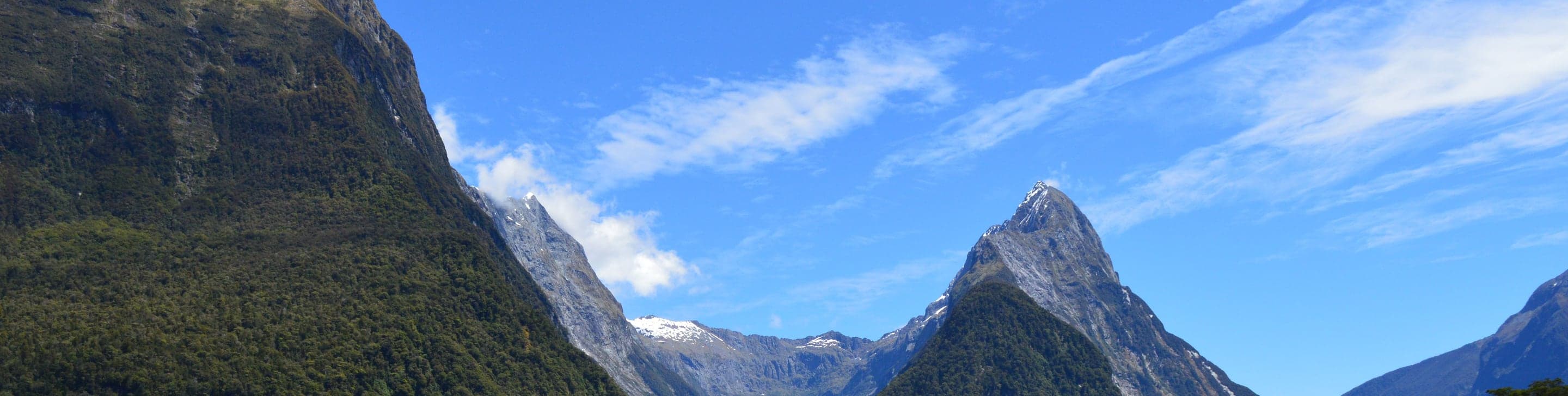 Milford Sound's fjords and mountains under a clear sky, New Zealand