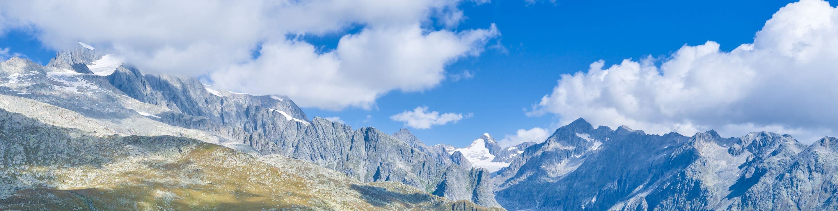 Aerial view of the Swiss Alps with a mountain lake and rugged peaks